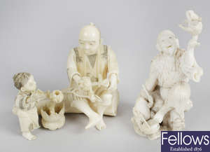 A 19th century oriental carved ivory figure group, together with another similar figure.