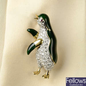 A pave-set diamond and deep green enamel penguin brooch, with ruby eye.
