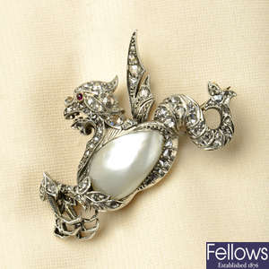 An early 20th century silver and gold, blister pearl, rose-cut diamond and ruby brooch, depicting a mythical creature.