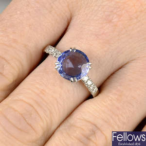 A Sri Lankan sapphire single-stone ring, with diamond line shoulders.