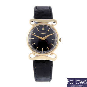 LONGINES - a mid-size yellow metal wrist watch.