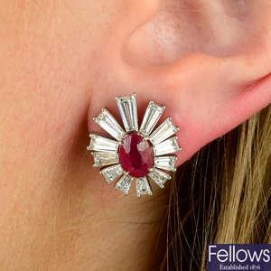 A pair of platinum, ruby and tapered baguette-cut diamond cluster earrings.