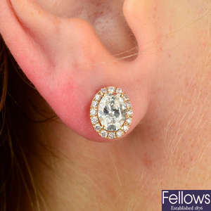 A pair of 18ct gold oval-shape and brilliant-cut diamond cluster earrings.