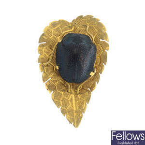 A novelty brooch, designed as a scarab on a leaf.