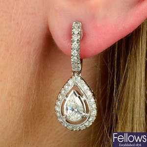 A pair of pear-shape and brilliant-cut diamond cluster drop earrings.