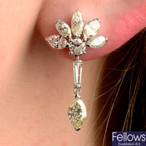 A pair of vari-cut diamond earrings.