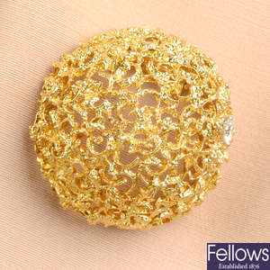 A mid 20th century textured dome brooch, with brilliant-cut diamond highlight, by Van Cleef & Arpels.