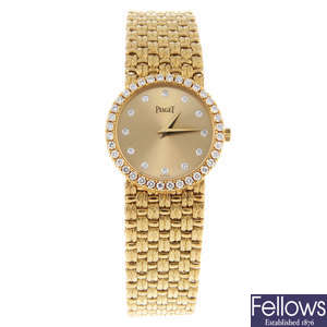 PIAGET - a lady's diamond set yellow metal bracelet watch.