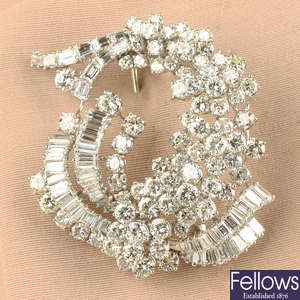 A mid 20th century brilliant and baguette-cut diamond cluster spray brooch.