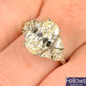 An oval-shape diamond ring, with triangular-shape diamond sides.