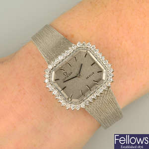 A 1970s 18ct gold 'De Ville' watch, by Omega, with brilliant-cut diamond bezel.