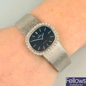 A 1970s 18ct gold 'De Ville' watch, by Omega, with brilliant-cut diamond bezel.