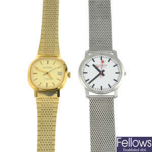 A group of eight assorted watches and a stopwatch.