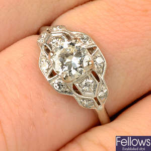 A circular-cut diamond ring, with single-cut diamond pierced geometric surround.