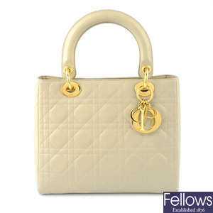 CHRISTIAN DIOR - a beige cannage leather Lady Dior handbag.