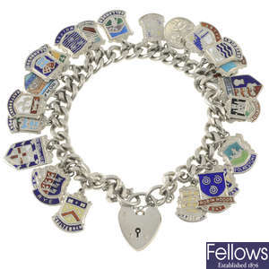 Seven charm bracelets and assorted charms.