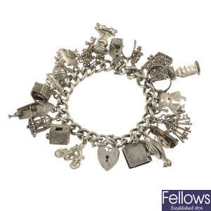 A silver charm bracelet with assorted charms.