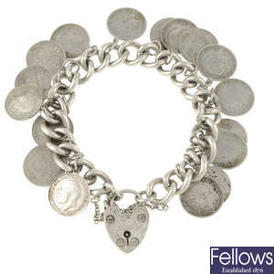 A silver charm bracelet with early 19th century three pence pieces.