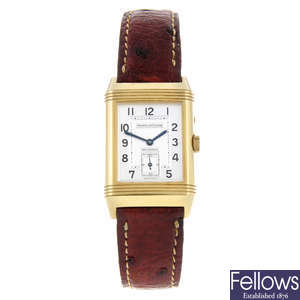 JAEGER-LECOULTRE - a gentleman's 18ct yellow gold Reverso Night & Day wrist watch.