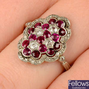 An early 20th century platinum ruby and vari-cut diamond cluster ring.