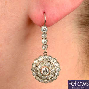A pair of diamond cluster drop earrings.