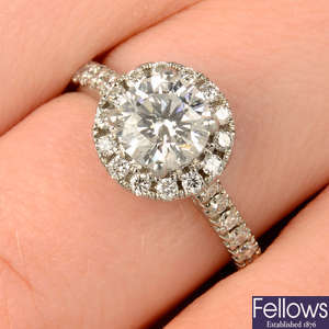 A platinum brilliant-cut diamond halo cluster ring.