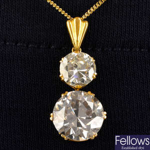 A circular-cut Light Pinkish Brown diamond and diamond graduated two-stone pendant, with 18ct gold chain.
