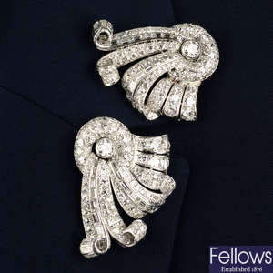 Two mid 20th century platinum vari-cut diamond clip brooches.