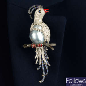 A pavé-set diamond, sapphire and black gem bird brooch, with grey baroque cultured pearl and enamel highlights.