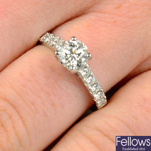 An 18ct gold brilliant-cut diamond ring, with diamond set shoulders.