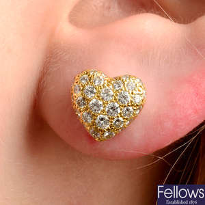 A pair of pavé-set diamond heart earrings, by Cartier.