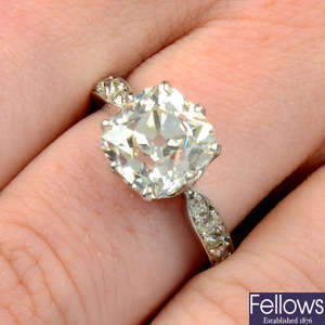 An old-cut diamond single-stone ring, with old-cut diamond line sides.