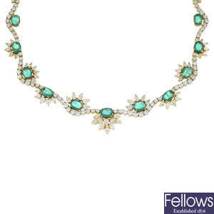 A graduated oval-shape emerald and brilliant-cut diamond undulating line necklace, with pear-shape diamond line highlights.