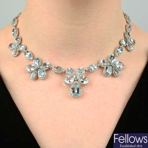 An 18ct gold aquamarine and diamond floral necklace.