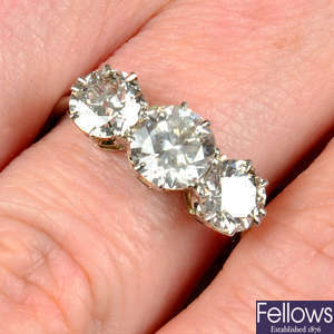 A mid 20th century platinum and 18ct gold graduated circular-cut diamond three-stone ring.