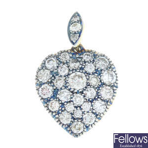 A brilliant-cut diamond heart-shape cluster pendant.