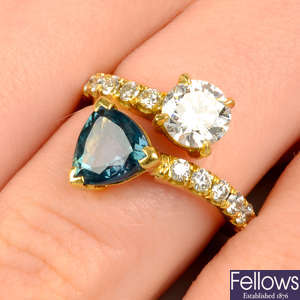 An 18ct gold alexandrite and diamond crossover ring, with diamond shoulders.