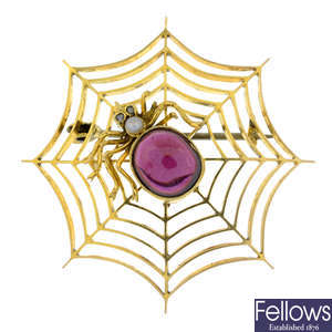 An early 20th century 15ct gold garnet cabochon, cultured pearl and rose-cut diamond spider brooch.