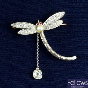 An early 20th century silver and gold, seed pearl, ruby and old-cut diamond dragonfly brooch.