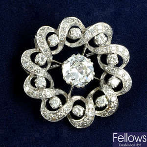 A circular-cut diamond wreath brooch.