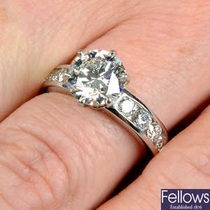 A platinum brilliant-cut diamond single-stone ring, with diamond shoulders, by Tiffany & Co.