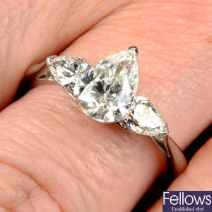 A pear-shape diamond three-stone ring.