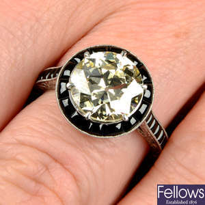 An old-cut diamond dress ring, with onyx surround and shoulders.