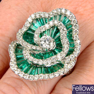 An emerald and diamond floral cocktail ring.