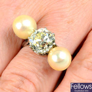 A mid 20th century platinum old-cut diamond and pearl three-stone ring.
