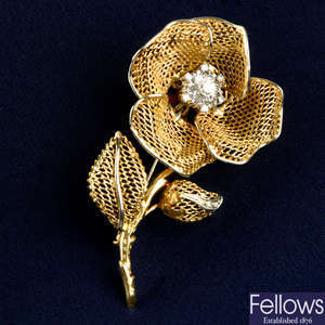 An 18ct gold openwork floral brooch, with diamond cluster highlight.