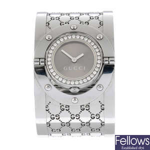 GUCCI - a diamond set stainless steel Twirl bangle watch, 33mm.