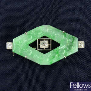 An Art Deco platinum and gold old-cut diamond and carved jade geometric brooch.