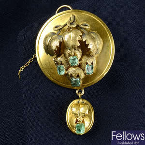 A mid 19th century gold emerald fruiting vine brooch, with glazed reverse and similarly-designed drop.