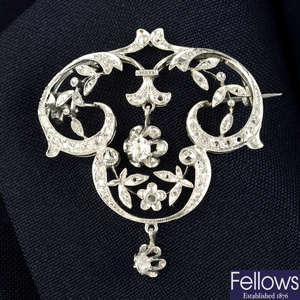 An Art Nouveau platinum old and rose-cut diamond scrolling floral brooch/pendant.